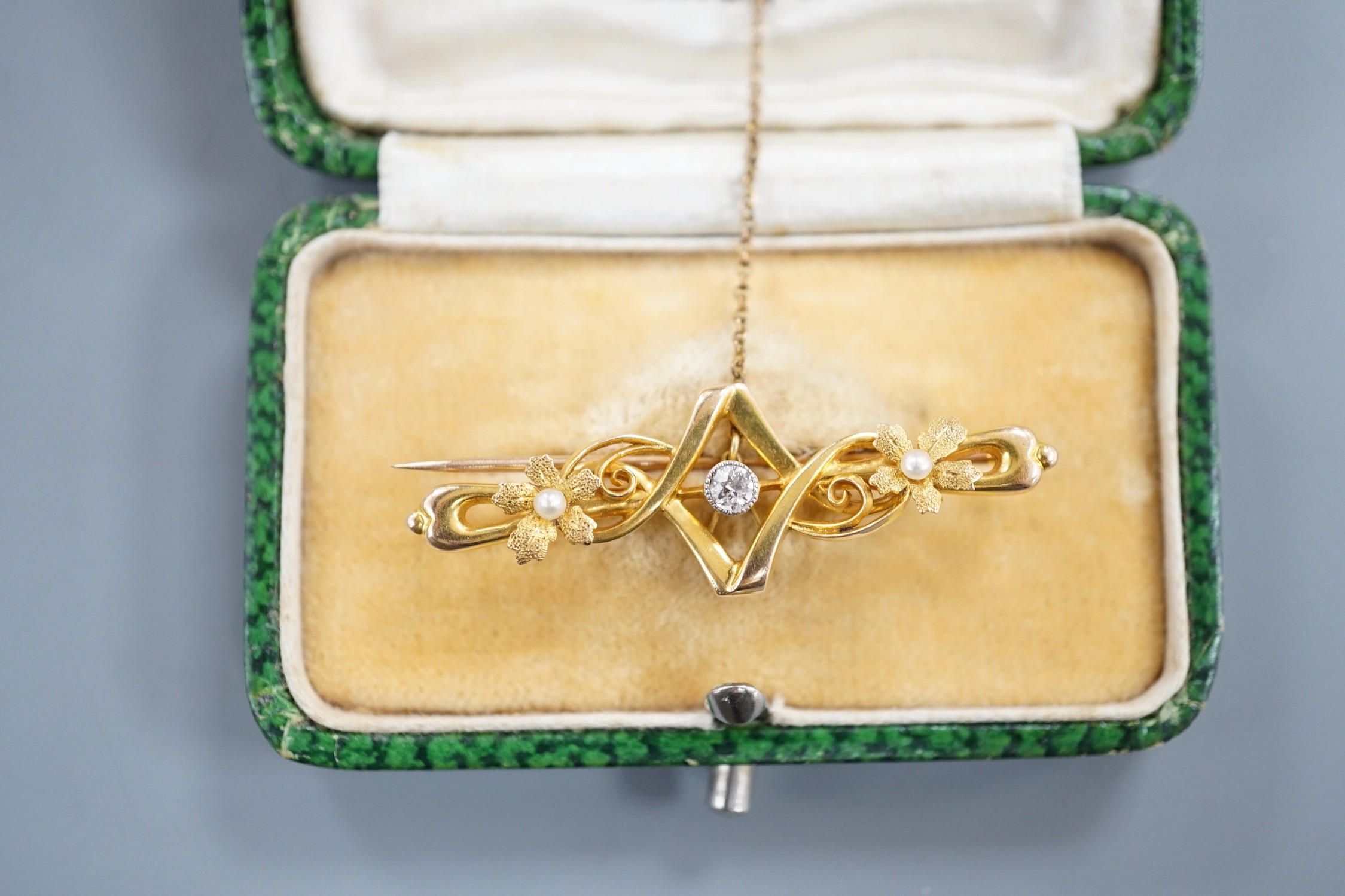 An Edwardian 15ct, seed pearl and diamond set bar brooch, 43mm, gross weight 3.1 grams.